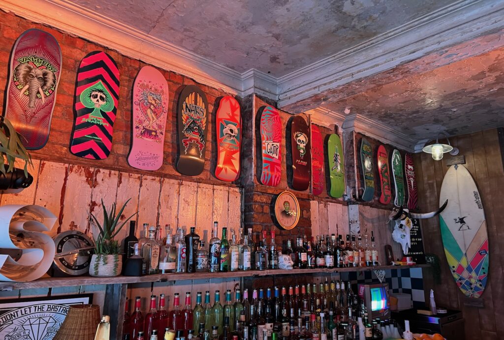 Dogtown surf and skate boards line the walls