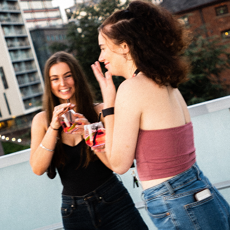 2 people drinking on balcony